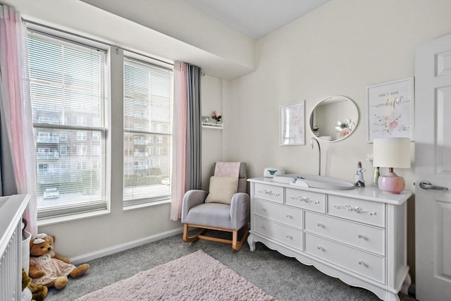 sitting room with plenty of natural light and light colored carpet