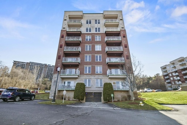 38 Village Rd Unit 309, Middleton, MA 01949 - view of apartment building / complex featuring uncovered parking