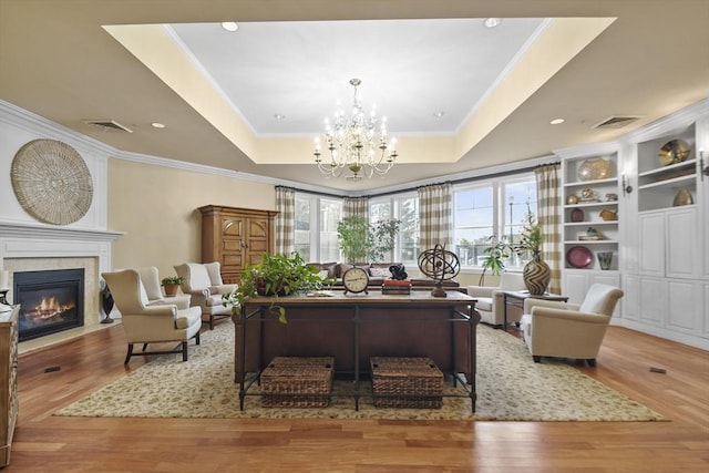 38 Village Rd Unit 309, Middleton, MA 01949 - living area featuring healthy amount of natural light, a tray ceiling, a fireplace with flush hearth, crown molding, and recessed lighting