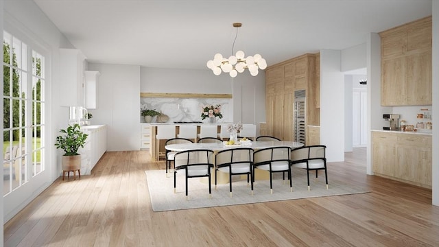 dining room featuring light wood finished floors and a chandelier