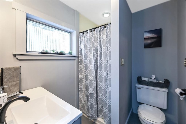 bathroom with curtained shower, a sink, and toilet