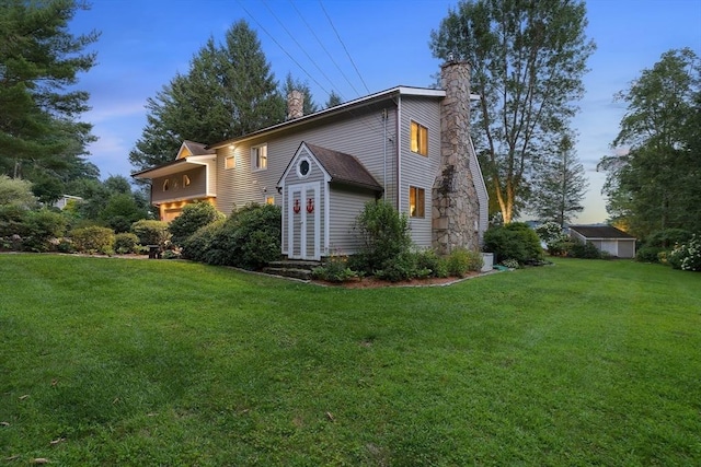 view of home's exterior with a yard and a chimney