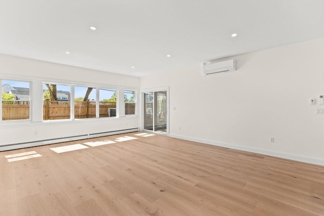 unfurnished room featuring a wall mounted air conditioner, baseboard heating, light wood-style flooring, recessed lighting, and baseboards
