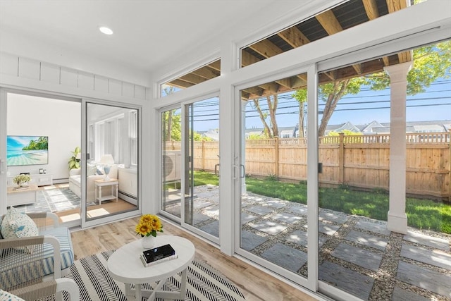sunroom featuring a baseboard heating unit