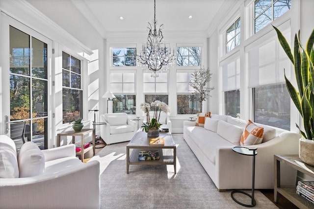 sunroom / solarium featuring an inviting chandelier