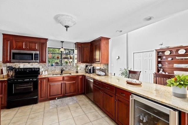 kitchen with light stone countertops, appliances with stainless steel finishes, a sink, beverage cooler, and backsplash