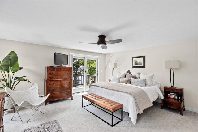 bedroom featuring access to outside, a ceiling fan, and light carpet