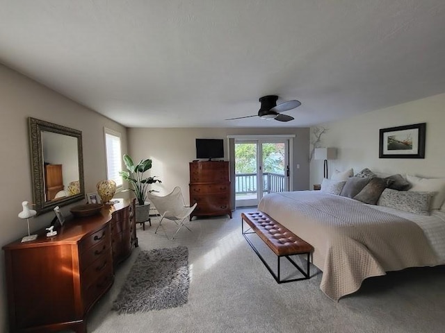 bedroom with a ceiling fan, access to exterior, multiple windows, and light carpet