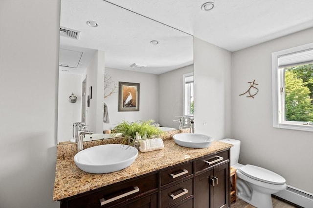 full bath featuring a sink, a baseboard heating unit, toilet, and visible vents