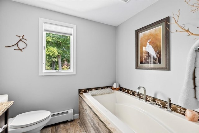 bathroom featuring vanity, wood finished floors, toilet, baseboard heating, and a bath