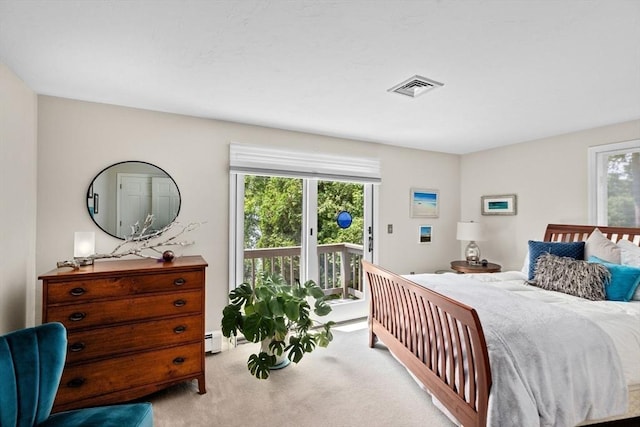 bedroom with visible vents, carpet, a baseboard heating unit, and access to exterior