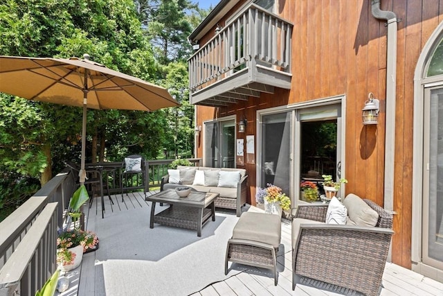 view of patio featuring an outdoor living space, a balcony, and a deck