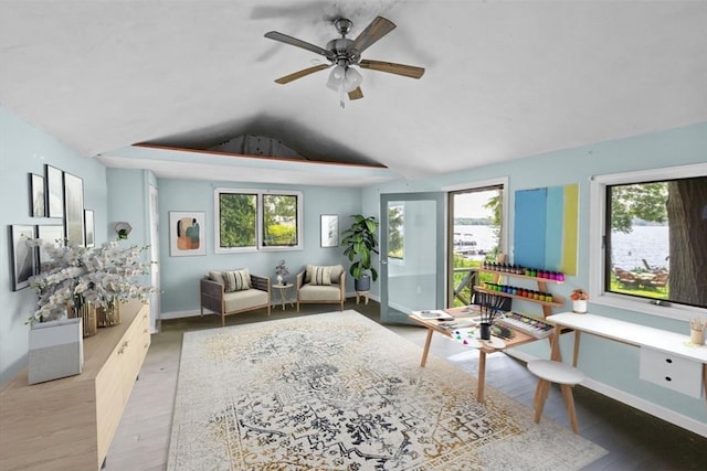 living area featuring plenty of natural light, lofted ceiling, and wood finished floors