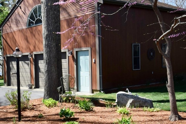 doorway to property with a garage and concrete driveway