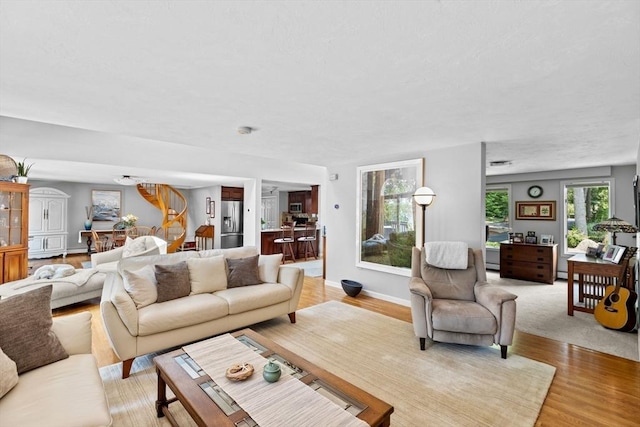 living room with baseboards and light wood-style floors