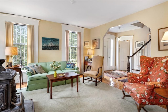167 Bakerville, Dartmouth, MA 02748 - living room featuring arched walkways, a wood stove, and carpet floors