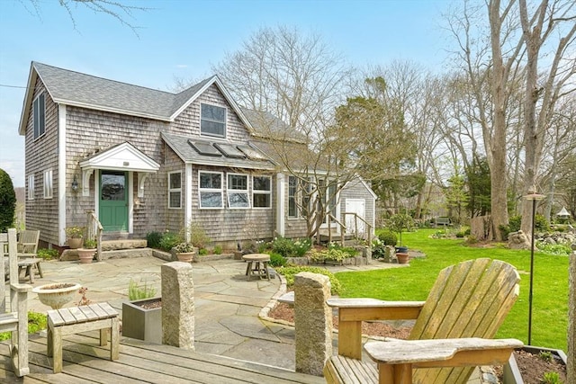 167 Bakerville, Dartmouth, MA 02748 - back of property with entry steps, a patio, an outdoor fire pit, a yard, and a shingled roof