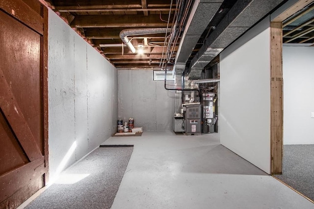 basement featuring water heater and heating unit