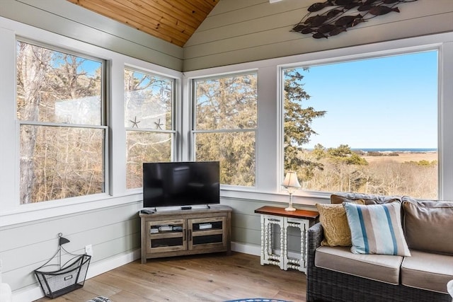 sunroom / solarium featuring a healthy amount of sunlight and vaulted ceiling