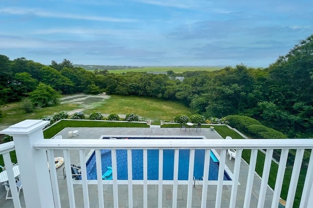 view of swimming pool with a fenced in pool and a lawn