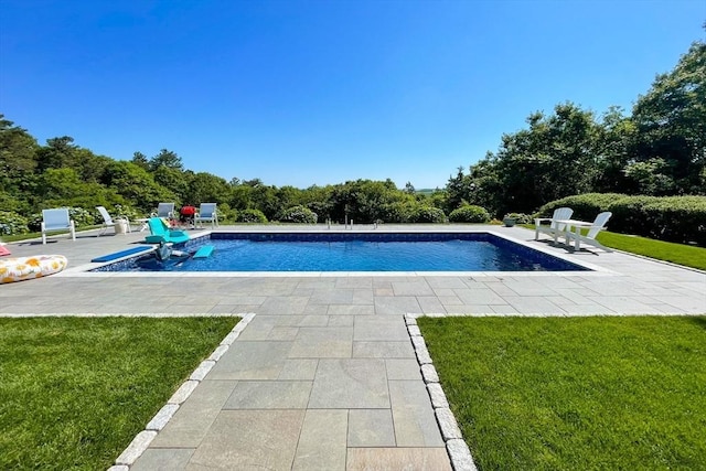 outdoor pool with a yard and a patio