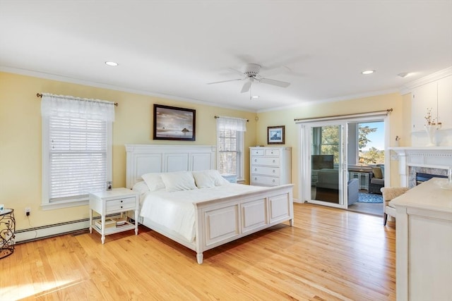 bedroom with a premium fireplace, ornamental molding, light wood-style floors, a baseboard heating unit, and access to outside