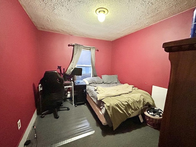 bedroom with carpet flooring and a textured ceiling