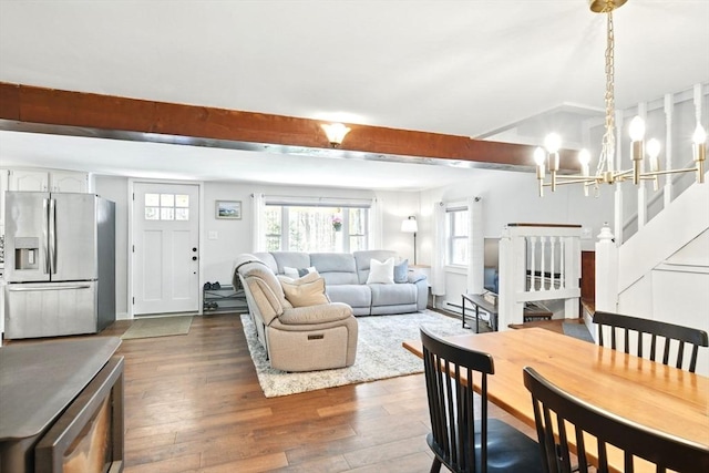 dining area with an inviting chandelier, dark wood-style floors, and a healthy amount of sunlight