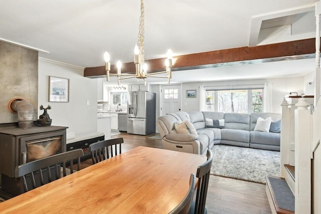 dining space with a notable chandelier and dark wood finished floors