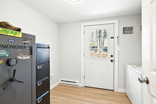 doorway to outside featuring baseboards, baseboard heating, and light wood finished floors