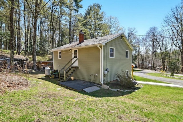 exterior space with a yard and a chimney
