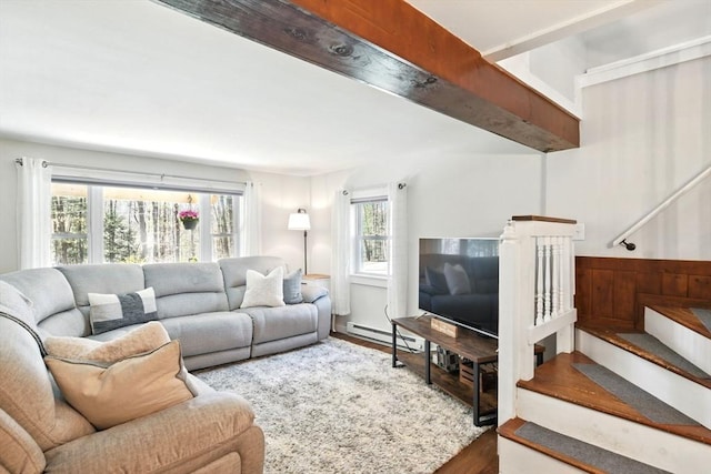 living room with stairs, wood finished floors, and baseboard heating