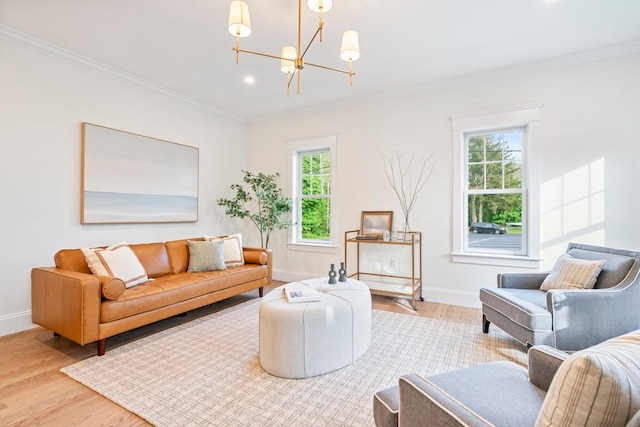 living room featuring a wealth of natural light, light hardwood / wood-style floors, and crown molding