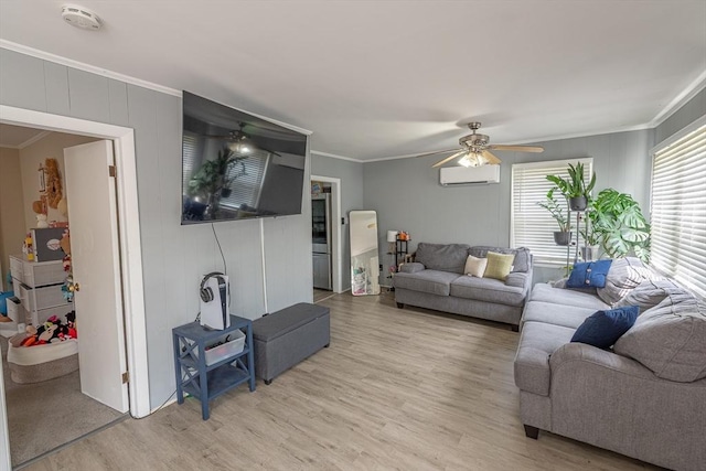 1001 Belleville Ave, New Bedford, MA 02745 - living room featuring a ceiling fan, an AC wall unit, light wood-type flooring, and ornamental molding