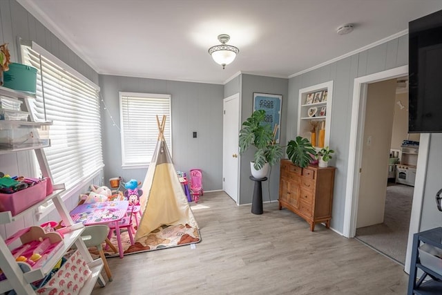 1001 Belleville Ave, New Bedford, MA 02745 - rec room with crown molding, light wood-style flooring, and wood walls