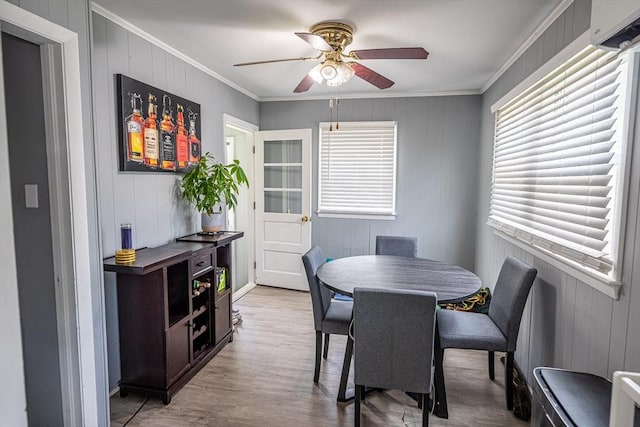 1001 Belleville Ave, New Bedford, MA 02745 - dining area with a ceiling fan, ornamental molding, light wood finished floors, wood walls, and an AC wall unit