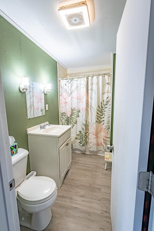 1001 Belleville Ave, New Bedford, MA 02745 - full bath featuring toilet, vanity, wood finished floors, and curtained shower