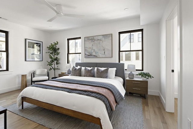 bedroom with ceiling fan and light hardwood / wood-style floors