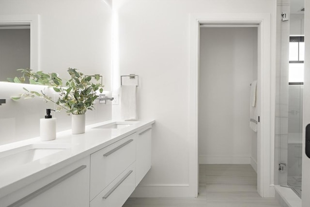 bathroom with vanity and a shower with shower door