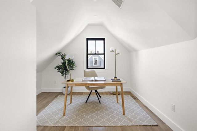 office with lofted ceiling and hardwood / wood-style floors