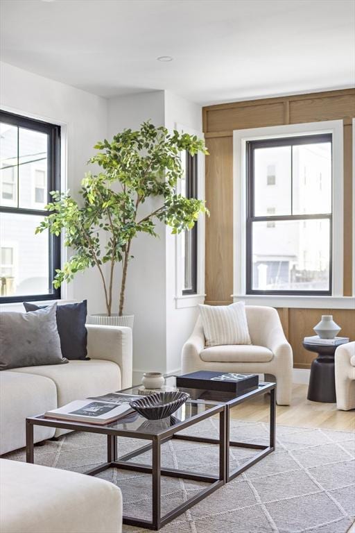 living room featuring hardwood / wood-style flooring and wooden walls