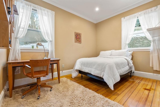 bedroom with crown molding and wood-type flooring