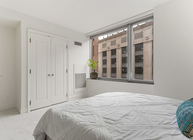 bedroom with carpet and a closet