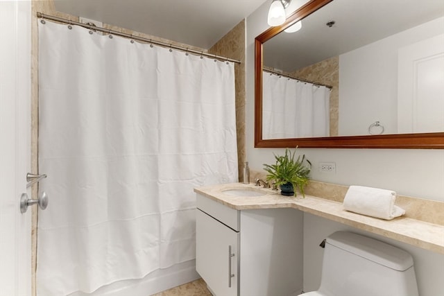 bathroom with toilet and vanity