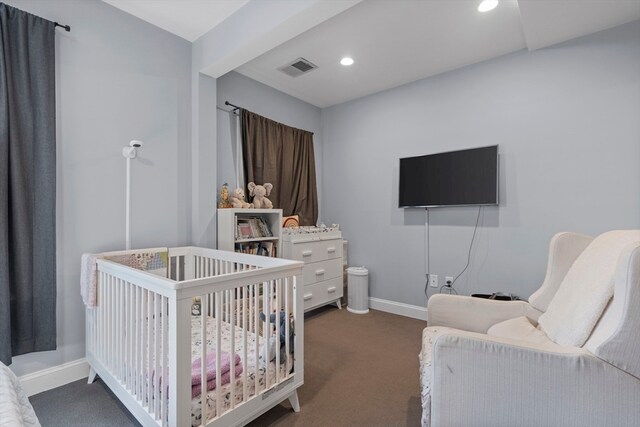 bedroom featuring carpet flooring and a crib