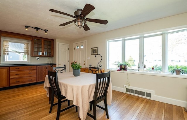 dining room featuring ceiling fan, baseboards, visible vents, and light wood-style flooring