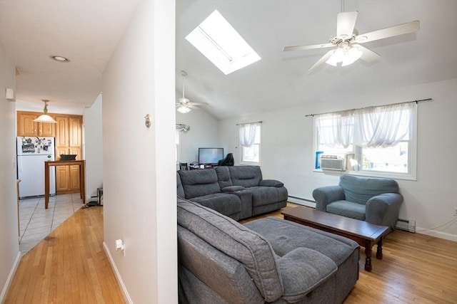 living area featuring a ceiling fan, baseboards, a baseboard radiator, a baseboard heating unit, and light wood-style flooring