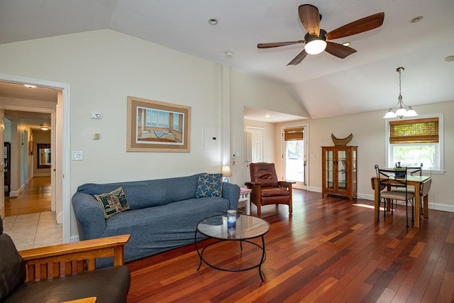 living room with wood-type flooring, lofted ceiling, and a healthy amount of sunlight