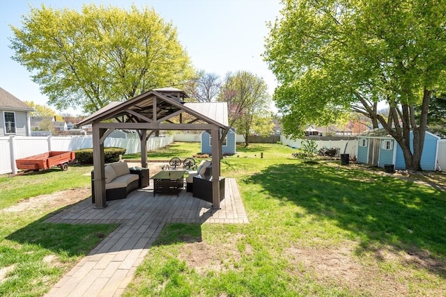 view of yard with a gazebo, a fenced backyard, outdoor lounge area, and a shed