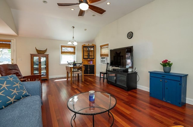 living area featuring cooling unit, hardwood / wood-style floors, a ceiling fan, baseboards, and vaulted ceiling